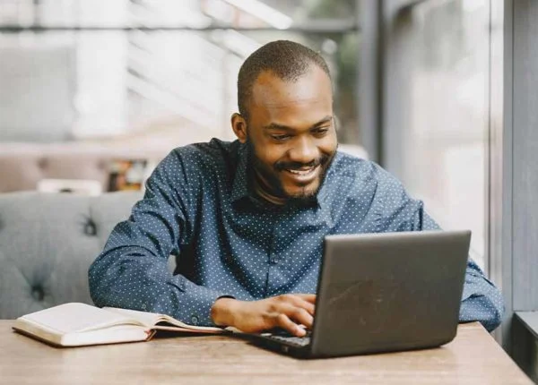 Advantages of e learning in education, male student working on laptop